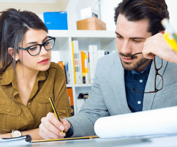 Two assignment writing experts are collaborating on a newly assigned task, reviewing the requirements and developing content tailored to the academic brief.