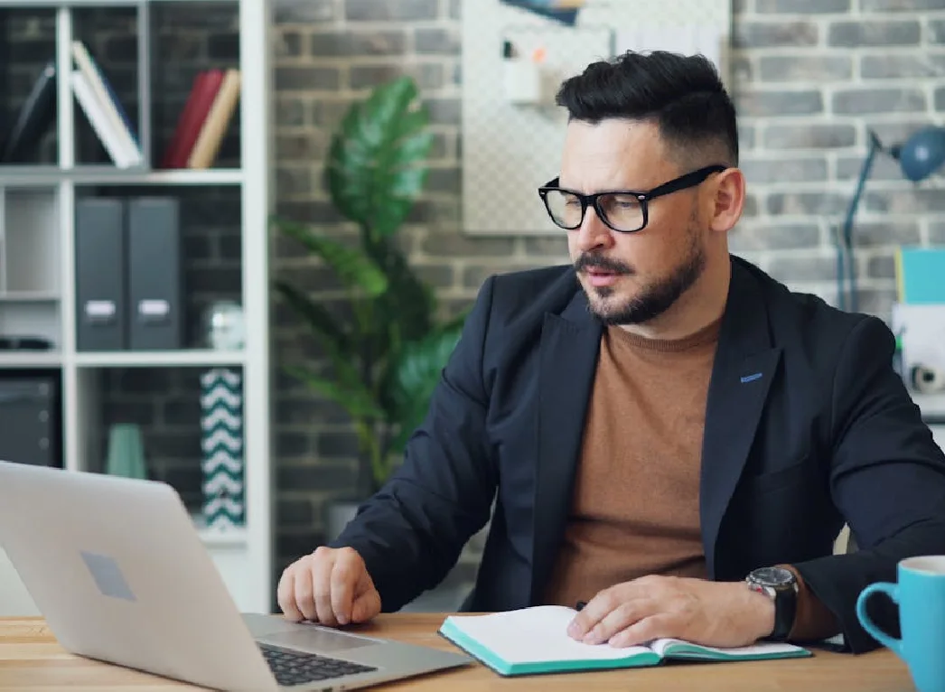 A student sitting in his study and writing his dissertation