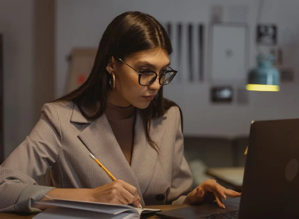 A girl completing her assignment at her home.